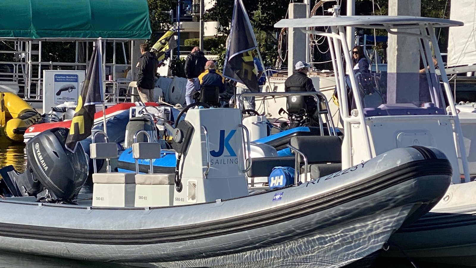 JK Sailing coach boat with staff at the dock