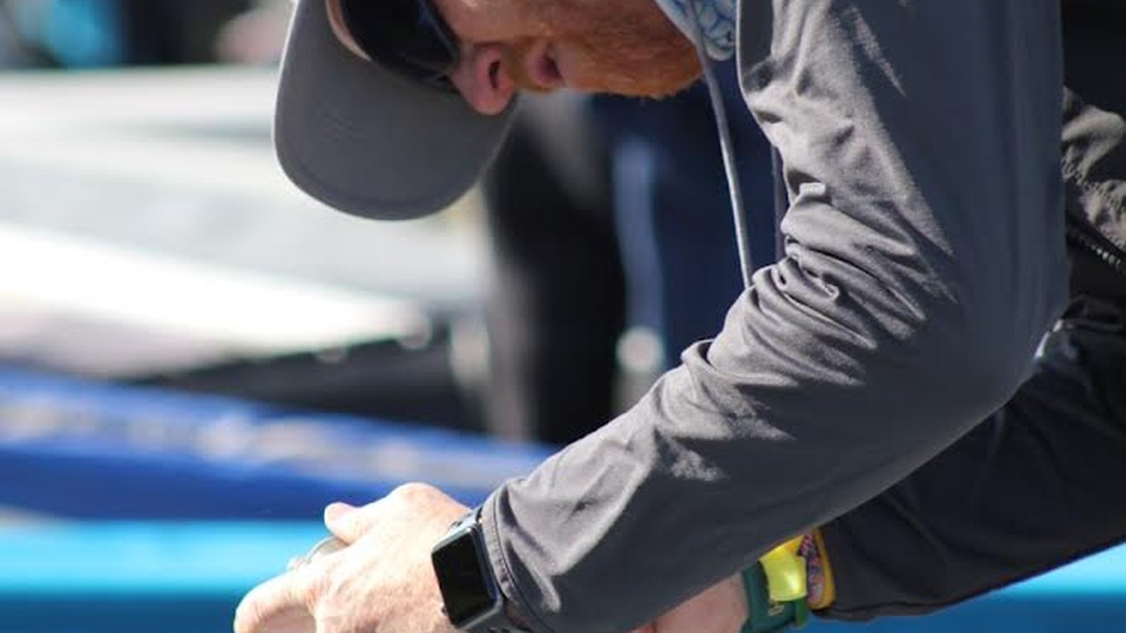 Coach rigging an Optimist sail by hand